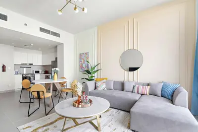 a living room with a couch and a table at Silkhaus brand new 1BDR in Creek Harbour in Dubai