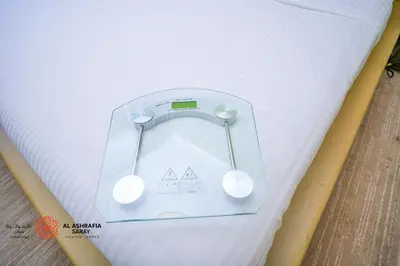 a pair of headphones on top of a mattress at Alashrafia Saray- Homey 1BR apartment in Sport City in Dubai