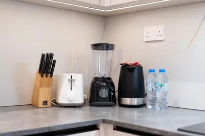 a kitchen counter with a blender and bottles of water at Upgraded 1Bedroom next to JBR Tourist Destination in Dubai
