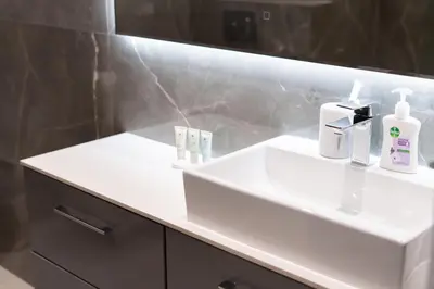 a bathroom with a white sink and a mirror at Upgraded 1Bedroom next to JBR Tourist Destination in Dubai