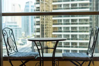 a table and two chairs in front of a window at Upgraded 1Bedroom next to JBR Tourist Destination in Dubai