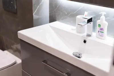 a bathroom with a sink with a soap dispenser on it at Upgraded 1Bedroom next to JBR Tourist Destination in Dubai
