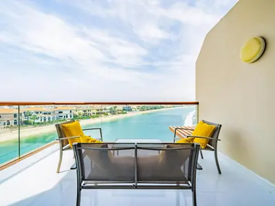 a balcony with a table and chairs and a view of the water at Paradise Studio in Palm Views - Palm Jumeirah in Dubai