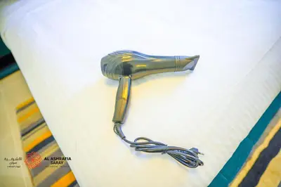 a blow gun sitting on top of a paper at Alashrafia Saray- Superior 1BR apartment in Sport City in Dubai