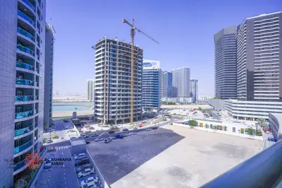 a view of a city with tall buildings and a crane at Alashrafia Saray- Superior 1BR apartment in Sport City in Dubai