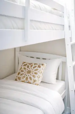 a white bunk bed with a pillow on top of it at Elite Royal Apartment Full Burj Khalifa & Fountain View - Czar in Dubai