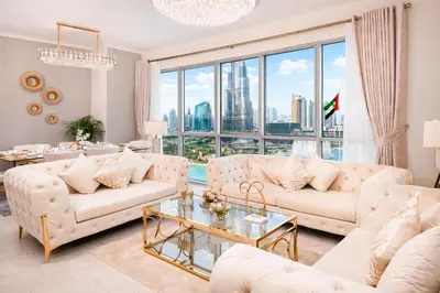 a living room with white furniture and a large window at Elite Royal Apartment Full Burj Khalifa & Fountain View - Czar in Dubai