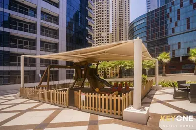 a park with a playground in a city at Chic Marina View Living in a Two Bedroom in Dubai