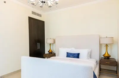 a bedroom with a bed with a blue pillow on it at CitiHome- Modern- 1BR Creek Residence in Dubai