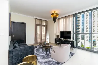 a living room with a couch and a tv at CitiHome- Modern- 1BR Creek Residence in Dubai