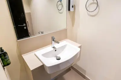 a white sink in a bathroom with a mirror at CitiHome- Modern- 1BR Creek Residence in Dubai