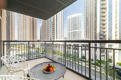 a bowl of fruit on a balcony with a view of the city at CitiHome- Modern- 1BR Creek Residence in Dubai