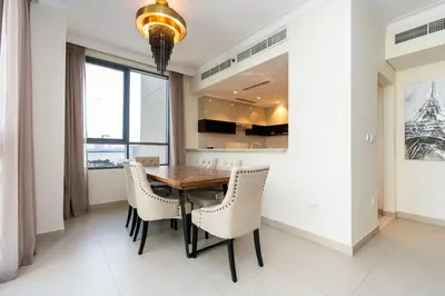 a dining room with a wooden table and chairs at CitiHome- Modern- 1BR Creek Residence in Dubai