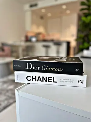 two books sitting on top of a white box at Panoramic 1br with Crystal Lagoon & Downtown View in Dubai