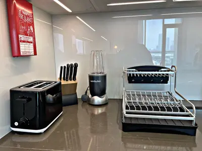 a kitchen counter with a toaster and a coffee maker at Panoramic 1br with Crystal Lagoon & Downtown View in Dubai