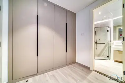a room with a large closet with a mirror at Picturesque Studio at Mesk 1 Midtown Dubai Production City by Deluxe Holiday Homes in Dubai