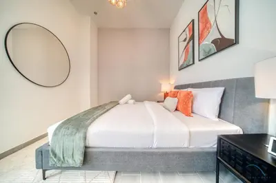 a bedroom with a bed and a mirror at Picturesque Studio at Mesk 1 Midtown Dubai Production City by Deluxe Holiday Homes in Dubai
