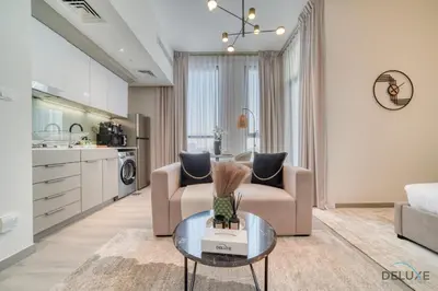 a living room with two chairs and a table at Graceful Studio at Mesk 1 Midtown Dubai Production City by Deluxe Holiday Homes in Dubai