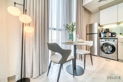 a kitchen with a table and chairs in a room at Classic Studio at Mesk 1 Midtown Dubai Production City by Deluxe Holiday Homes in Dubai