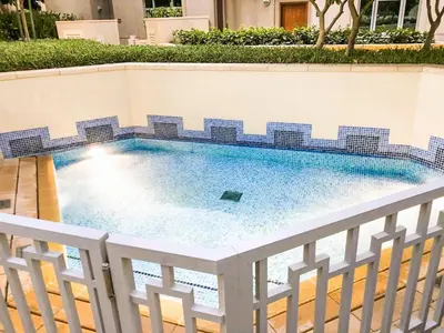 a swimming pool with blue tiles on a fence at Elite Royal Apartment - Full Burj Khalifa & Fountain View - King in Dubai