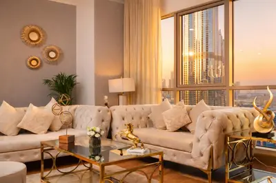 a living room with a couch and a large window at Elite Royal Apartment - Full Burj Khalifa & Fountain View - King in Dubai