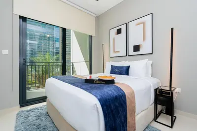 a bedroom with a large bed and a large window at CitiHome -1BR with Balcony & Pool View in Zada Tower in Dubai