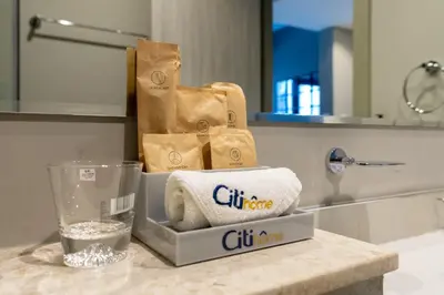 a pile of towels on a counter in a bathroom at CitiHome -1BR with Balcony & Pool View in Zada Tower in Dubai