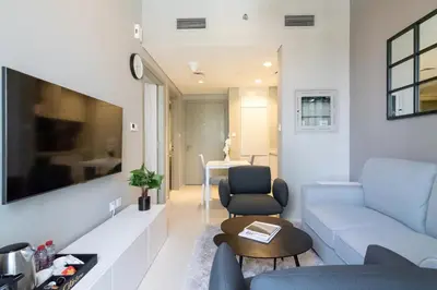 a living room with a couch and a table at CitiHome -1BR with Balcony & Pool View in Zada Tower in Dubai