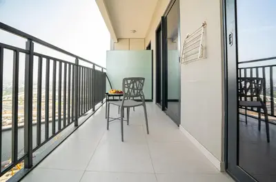 a balcony with two chairs and a table on it at CitiHome - Newly Furnished Apartment in Business Bay in Dubai