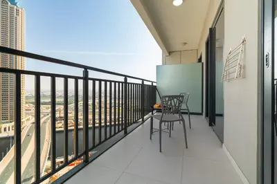 a balcony with a table and chairs on a building at CitiHome - Newly Furnished Apartment in Business Bay in Dubai