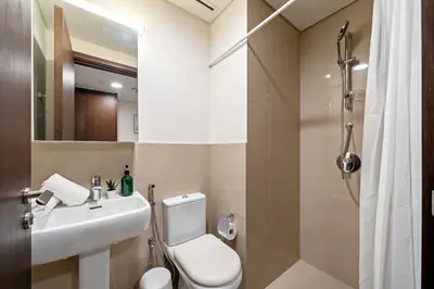 a bathroom with a sink and a toilet and a shower at Chic & Trendy 3BR+kid's in Vibrant Downtown Dubai in Dubai