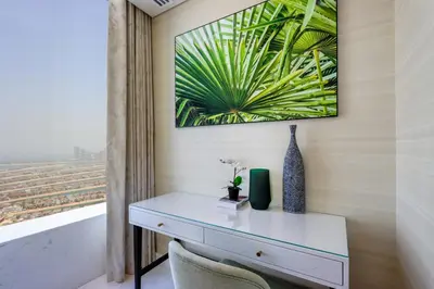 a desk in a room with a painting on the wall at Livbnb - 1BR w/Spectacular Sea Views in Palm Tower in Dubai