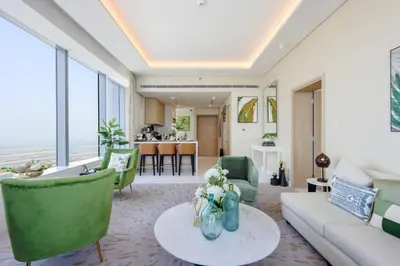 a living room with a couch and chairs and a table at Livbnb - 1BR w/Spectacular Sea Views in Palm Tower in Dubai