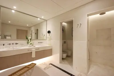 a bathroom with a tub and a sink and a shower at Livbnb - 1BR w/Spectacular Sea Views in Palm Tower in Dubai