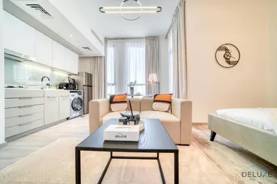 a living room with a couch and a table at Distinguished Studio at Mesk 1 Midtown Dubai Production City by Deluxe Holiday Homes in Dubai