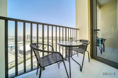a balcony with a table and chairs and a view at Incredible Studio at Mesk 1 Midtown Dubai Production City by Deluxe Holiday Homes in Dubai