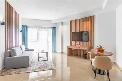 a living room with a couch and a table at Pyramisa Hotel Apartments in Dubai