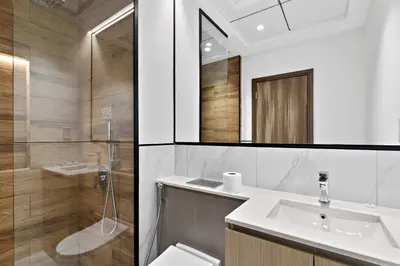 a bathroom with a sink and a shower and a toilet at ALiving Duplex Studio I Aria Residence by Grovy, JVC in Dubai