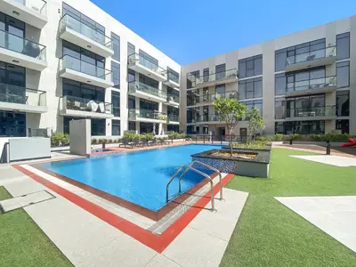 a swimming pool in the middle of a building at ALiving Duplex Studio I Aria Residence by Grovy, JVC in Dubai