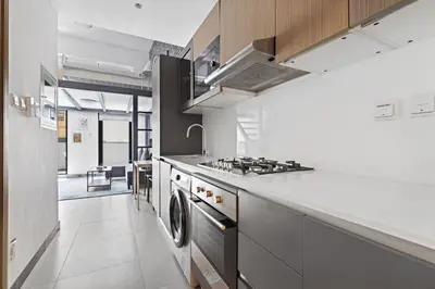 a kitchen with a stove and a stove top oven at ALiving Duplex Studio I Aria Residence by Grovy, JVC in Dubai