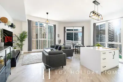 a living room with a couch and a table at LUX The Dubai Marina View Suite in Dubai