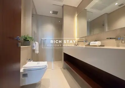 a bathroom with a white toilet and a mirror at Phenomenal 1BR in Marina Gate 2,Full Marina View in Dubai