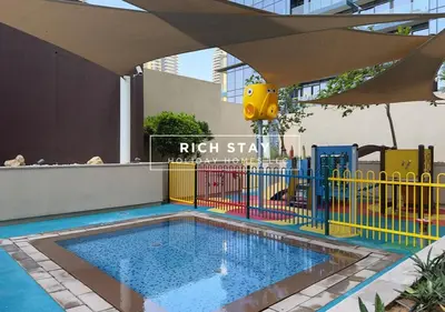 a swimming pool with a colorful fence around it at Phenomenal 1BR in Marina Gate 2,Full Marina View in Dubai