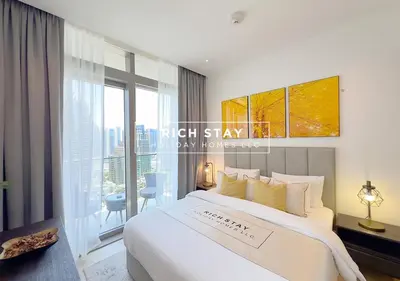 a bedroom with a large bed and a large window at Phenomenal 1BR in Marina Gate 2,Full Marina View in Dubai