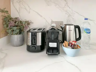 a toaster and coffee maker on a kitchen counter at Trophy 2BDR Sandy Shores Retreat with Panoramic Sea View & Private Beach Access in Dubai