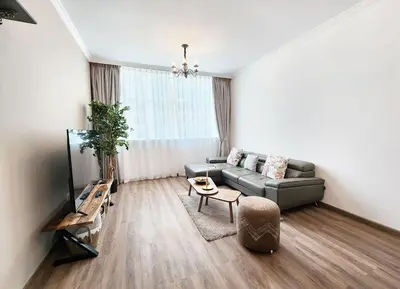 a living room with a couch and a table at RH- Luxurious Retreat, Spacious 01 BR, near Burj Khalifa and Dubai mall in Dubai