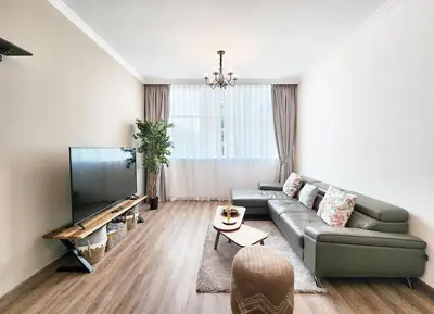 a living room with a couch and a flat screen tv at RH- Luxurious Retreat, Spacious 01 BR, near Burj Khalifa and Dubai mall in Dubai
