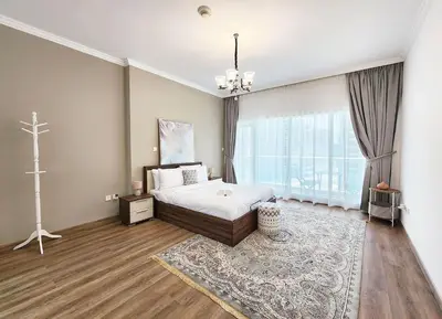 a bedroom with a bed and a cross on the wall at RH- Luxurious Retreat, Spacious 01 BR, near Burj Khalifa and Dubai mall in Dubai