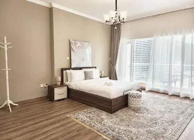 a bedroom with a bed and a large window at RH- Luxurious Retreat, Spacious 01 BR, near Burj Khalifa and Dubai mall in Dubai
