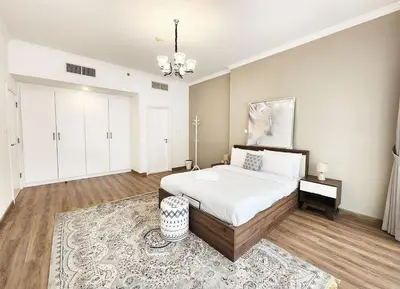 a large bedroom with a bed and a rug at RH- Luxurious Retreat, Spacious 01 BR, near Burj Khalifa and Dubai mall in Dubai